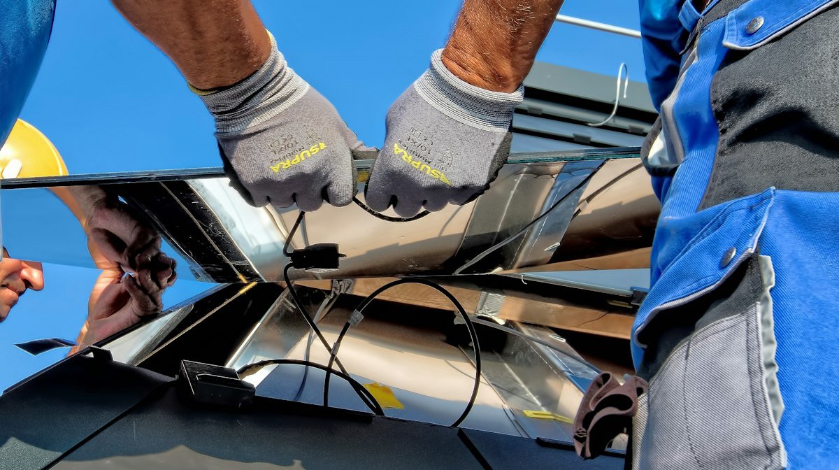 Technician connecting solar panel wiring